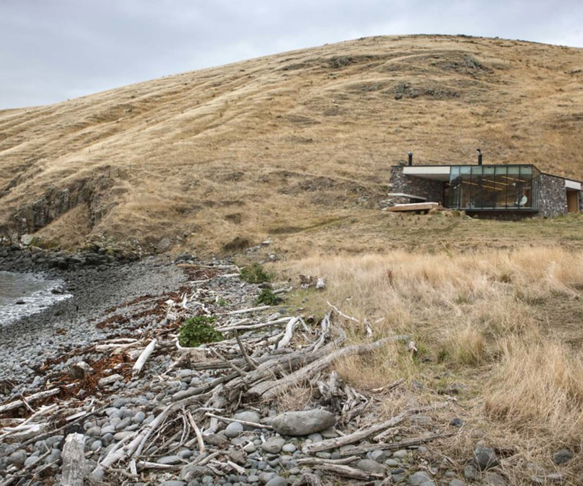 The view of the home from the rocky beach, where seals sometimes loll.