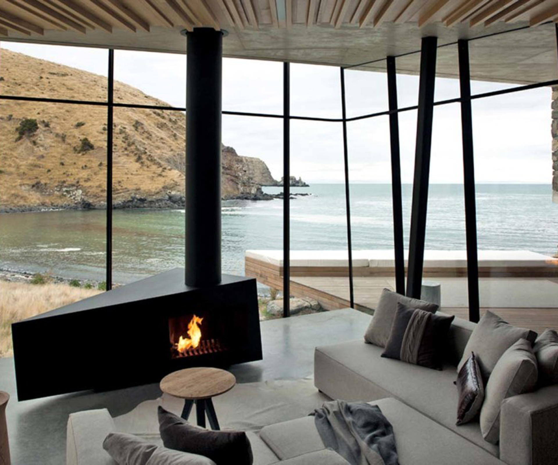 Inside, the home is really just one room with a bed, a fireplace and sitting area, and a small kitchen.