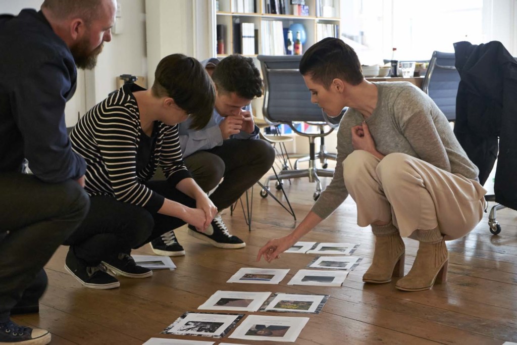 Art director Arch MacDonnell, senior designer Sarah Gladwell and designer Oliver Worsfold review layouts for our 'Global Villages' issue with Karen Walker. Photograph by Mark Smith. 