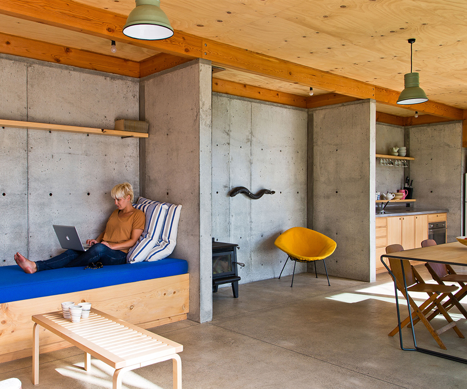 Architectural graduate Sally Ogle of Patch Work Architecture reclines in the downstairs living area on the daybed.