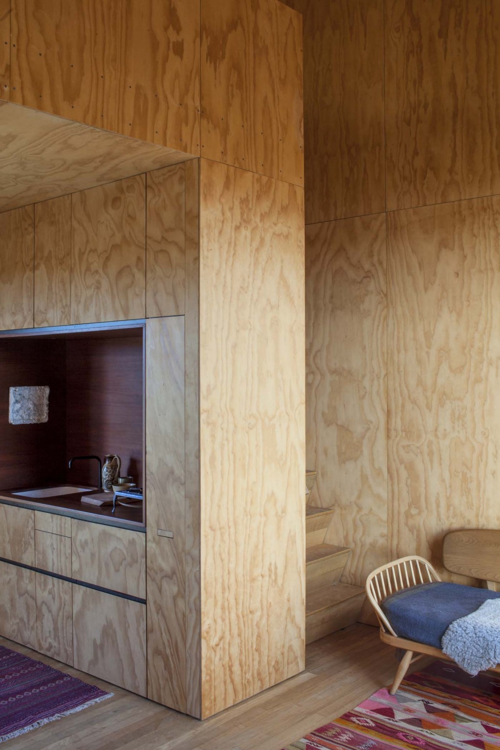 The stairs to the sleeping area are tucked behind the kitchen in each cabin. Photograph by Darryl Ward. 