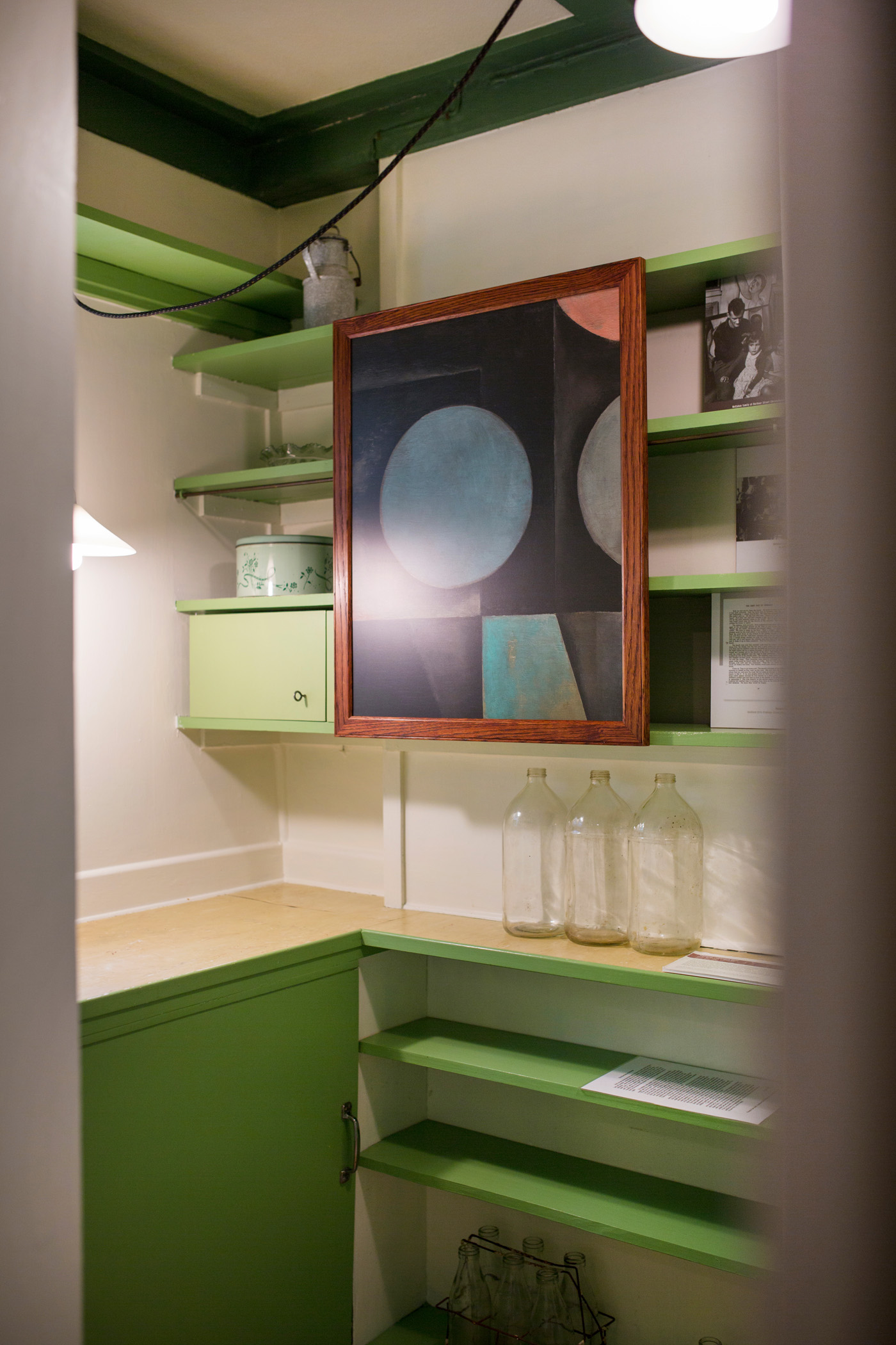 A reproduction of 'Titirangi Cupboard Door' (circa 1953) by Colin McCahon is surrounded by family mementoes. Photograph by Jeremy Toth.