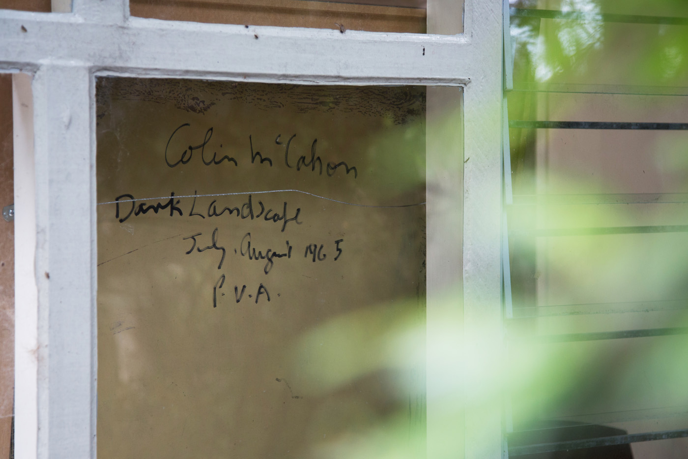 The verso of McCahon's 'Dark Landscape' (1965) is photographed through the living room window. Photograph by Jeremy Toth.