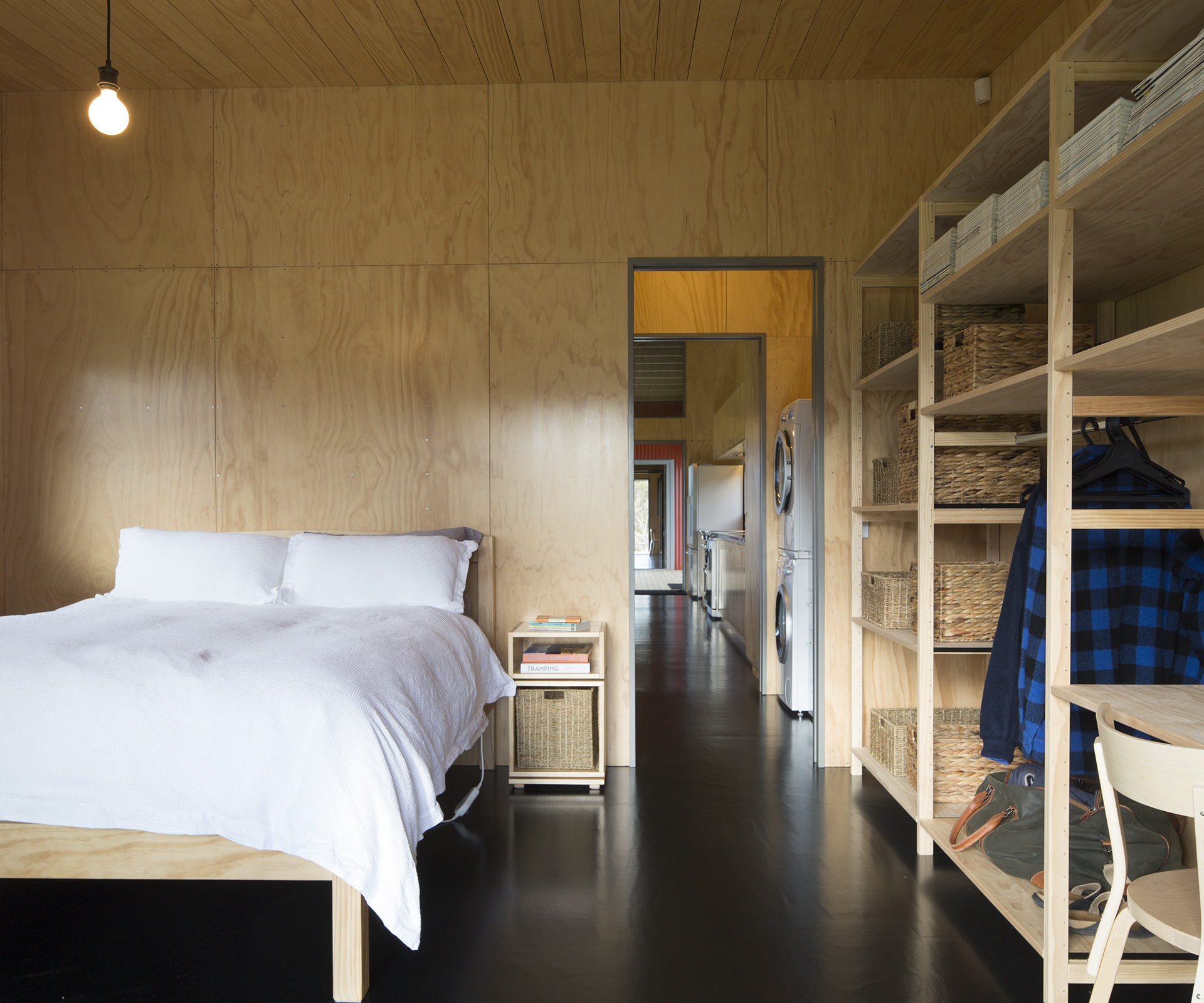 In the bedrooms, furnishing and storage, such as the shelving by Lundia, are deliberately pared back and humble in nature.