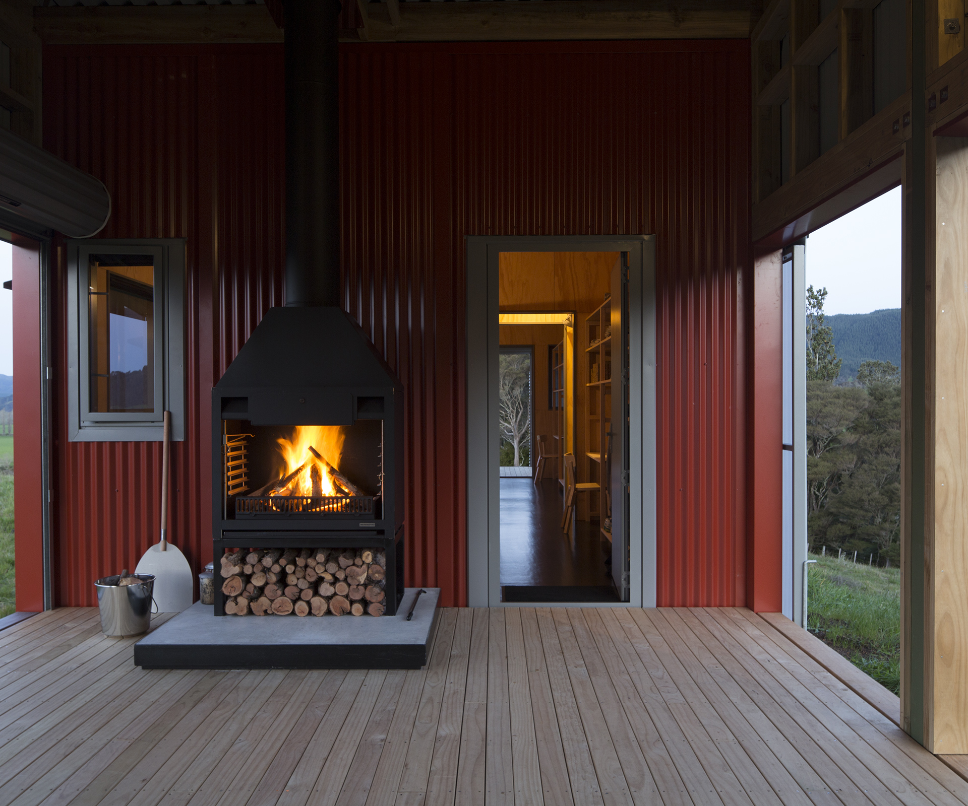 On the central covered deck, the fireplace by Fires by Design provides warmth in all weathers.