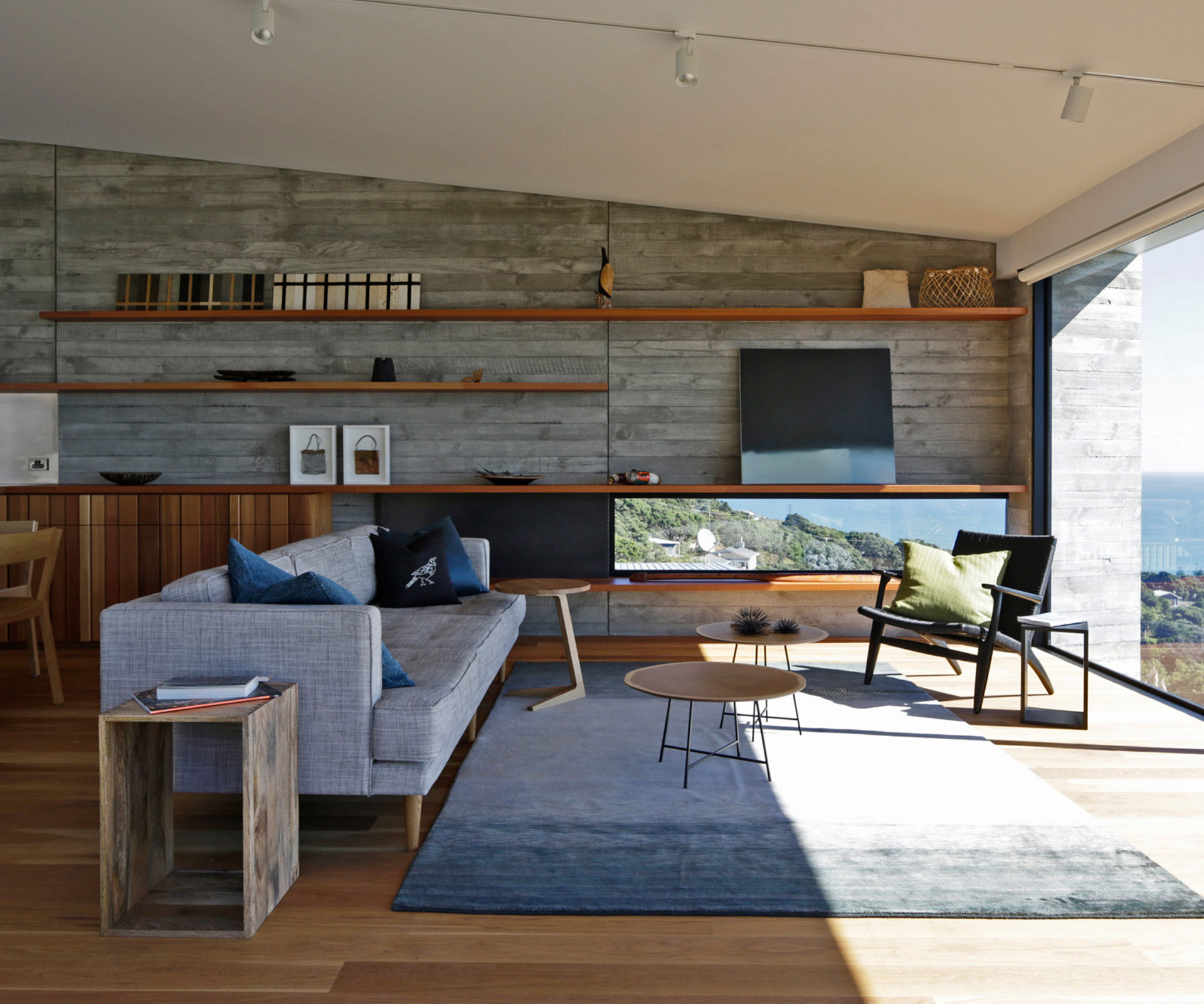 The home's living space features large windows looking towards the horizon, and a low window offering views to the south. Photograph by Patrick Reynolds