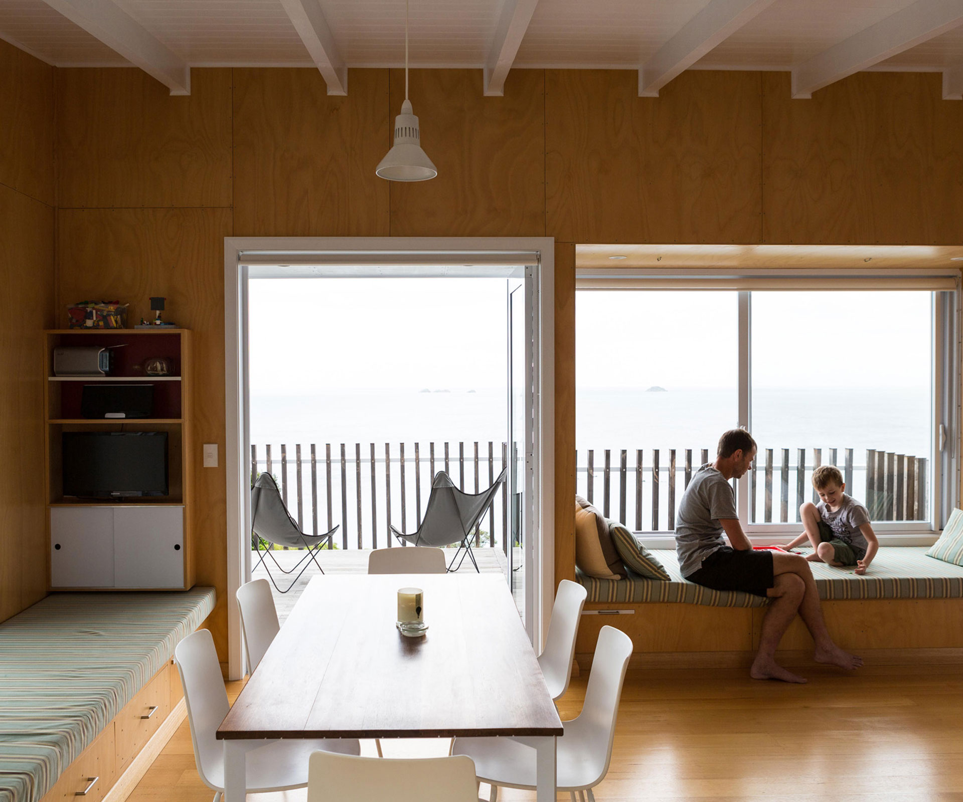 The Rakino Island bach keeps its small interior simple with built-in window seats allowing big sea views.