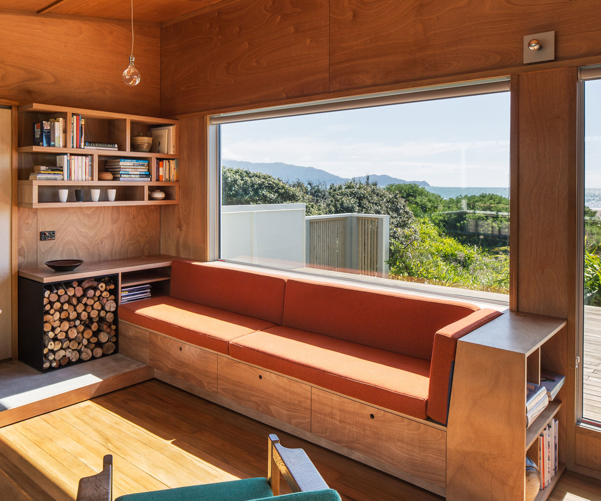 Built-in seating offers a view of the Kapiti Coast beach outside this bach renovated by Gerald Parsonson of Parsonson Architects. Photograph by Paul McCredie