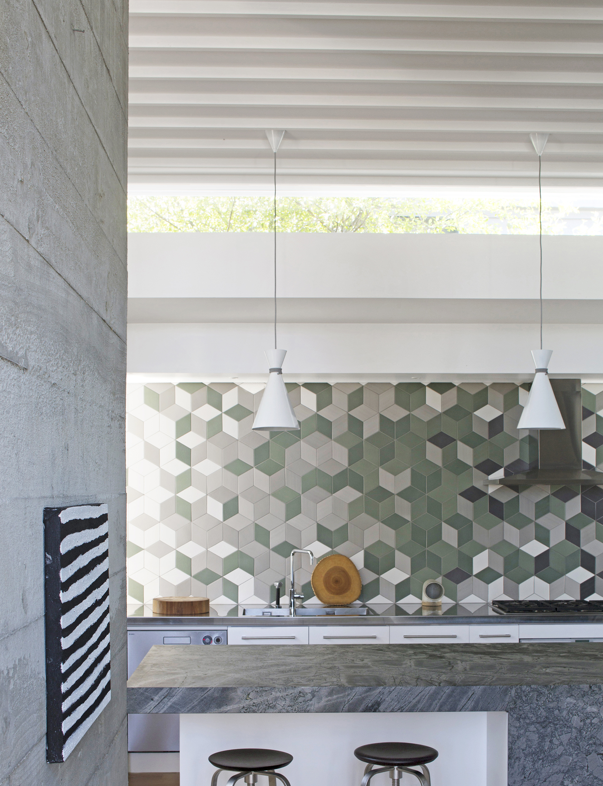 When designing the layout of the tiles for the kitchen splashback, John wanted the result to be “chaotic and adventurous”.