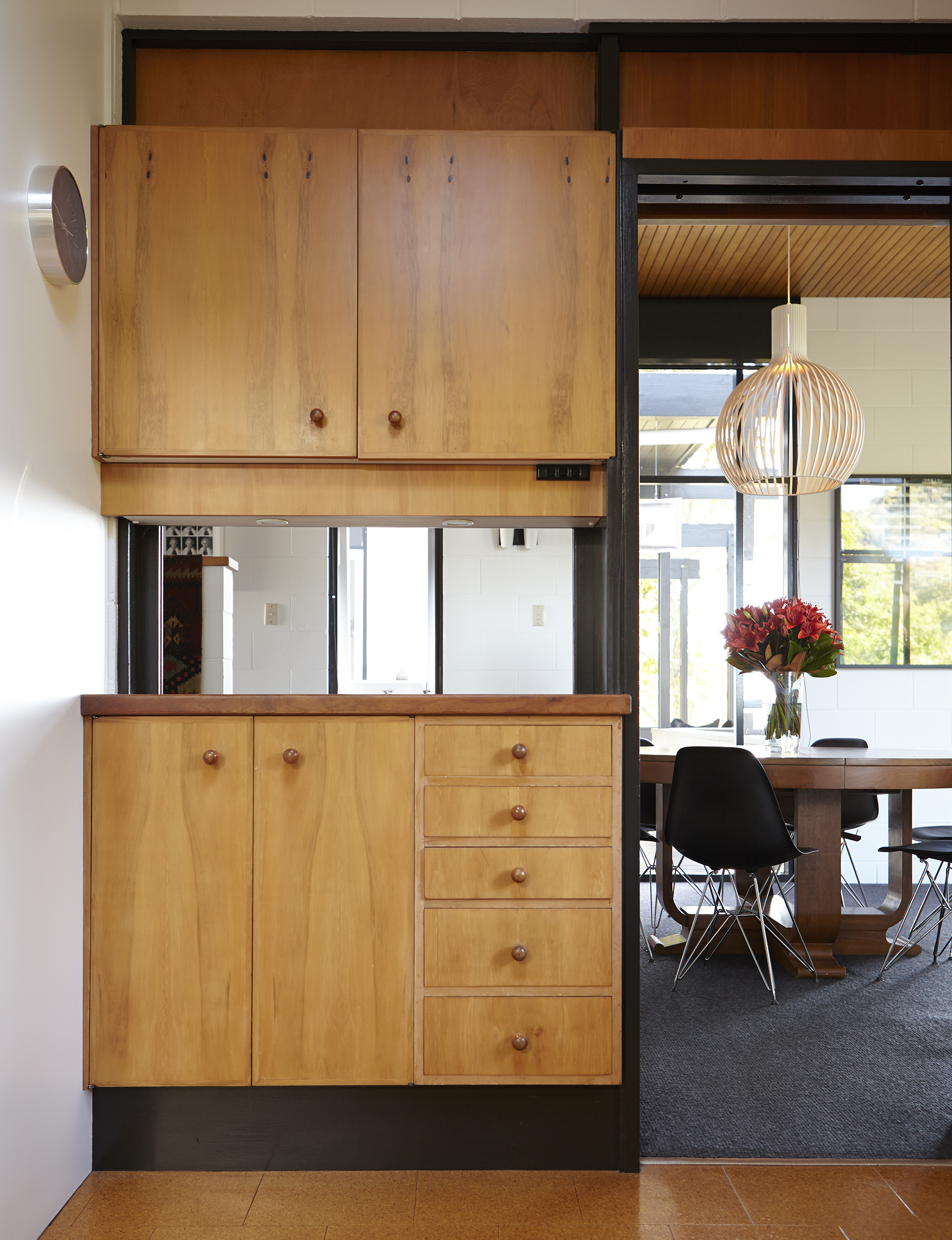 Looking through to the dining room from the kitchen, where an Art Deco teak table from Singapore is paired with ‘Eiffel’ chairs by Charles and Ray Eames for Herman Miller. The butler’s pass is an original feature and the dining room can be closed off from the kitchen.
