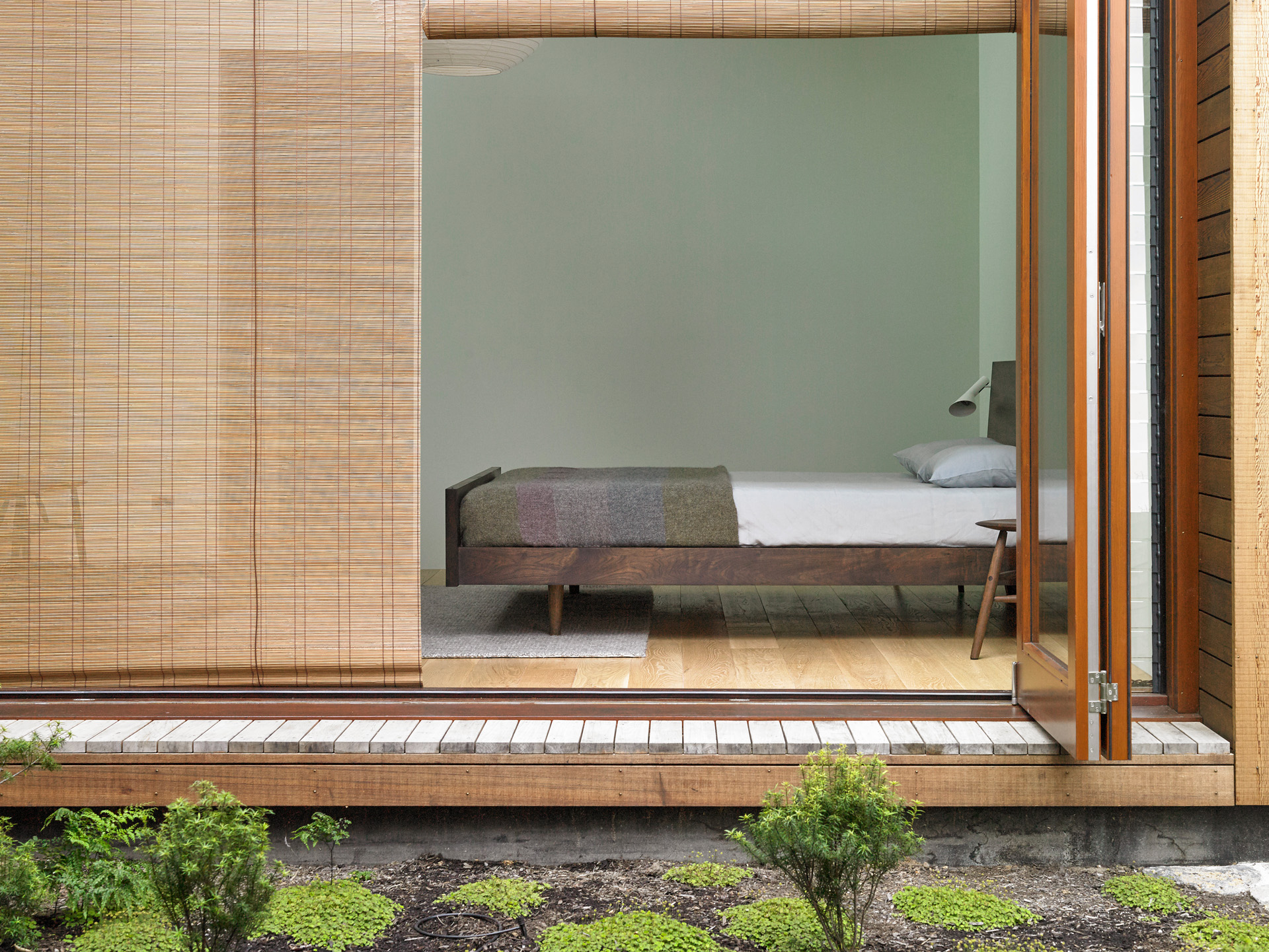 A bedroom looks onto a courtyard garden. Photo by Mark Smith. 