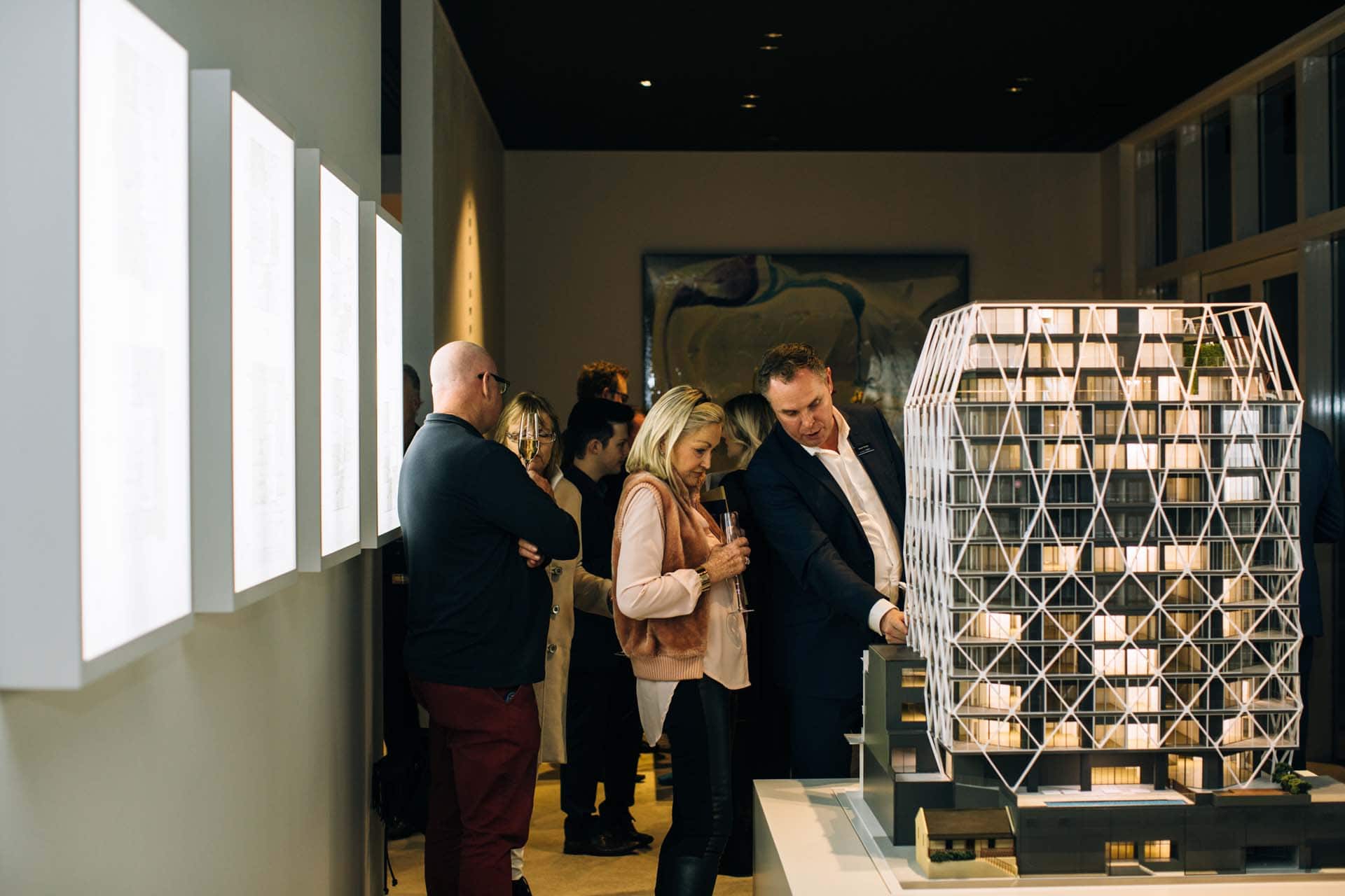 Guests with a model of the building in The International's show suite. 