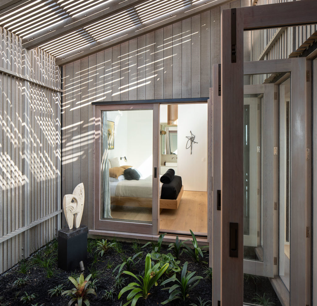 A view of the bedroom from outside through the large doors